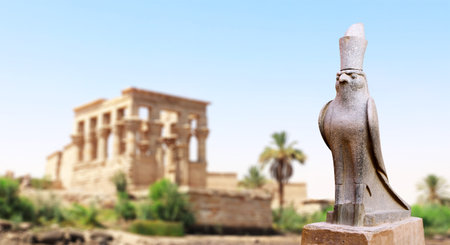Horizontal banner with granite statue of falcon God Horus, palm and ancient columns, Karnak Temple Complex, Luxor (ancient Thebes), Egypt, North Africaの写真素材