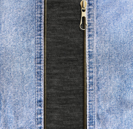 Square background with blue denim borders, zipper opened and black cotton texture. Decorative backdrop with Unzipped zipper or fastener, light blue and gray color jeans fabric. Copy space for textの写真素材