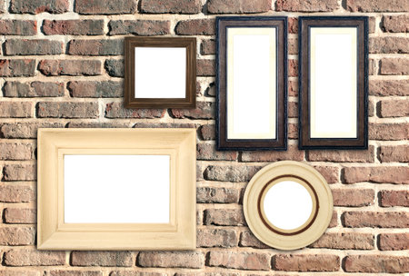 Horizontal banner with blank picture frames hanging on brick wall. Empty photo frame set on wall background. Mock up poster frame template for decor room. Retro Interior design. Copy space for textの写真素材