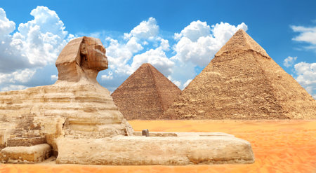 Famous Great Sphinx and pyramids of Chephren, Cheops, Menkaure, Cairo, Egypt. Great Pyramids and statue of Sphinx, mythical creature with head of man and body of lion, Giza complex (Giza Necropolis)の写真素材