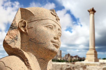 Famous landmark - Serapeum of Alexandria. Sphinx and Pompey's Pillar in Alexandria, Egypt, North Africa. Roman temple Serapeum with Pompey's pillar and sphinxの写真素材