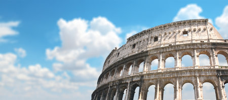 Horizontal banner with ancient Colosseum in Rome, Italy. Roman  Colosseum on blue sky background. Topic of vacation, travel, trip abroad on vacation, cruises and toursの写真素材
