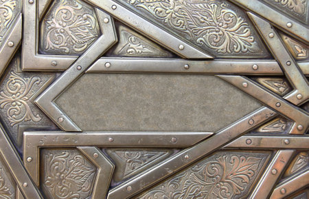 Frame with traditional islamic ornament. Copper window shutter with antique and national moroccan floral pattern. Oriental ornaments with artistic with chasing for brass. Copy space for textの写真素材