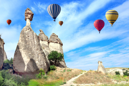Balloon flight, famous tourist attraction of Cappadocia. Air balloons and Fairy Chimney in Pasabag Valley, Anatolia, Turkey. Topic of vacation, travel, trip abroad on vacation, cruises and toursの写真素材