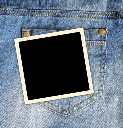 Nostalgic scrapbooking banner with jeans pocket of indigo color and retro frame photo. Vertical background with denim texture of blue color and blank photo. Vintage style backdrop with copy spaceの写真素材