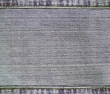 Gray denim background with a seamed frame. Grey color denim jeans fabric texture with decorative stitch border. Copy space for textの写真素材