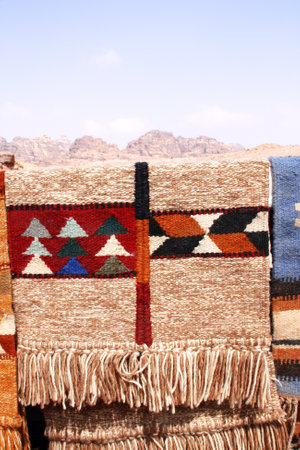 Colorful handmade carpets at a outdoors bazaar, Petra (Red Rose City), Jordan. Traditional jordanian...