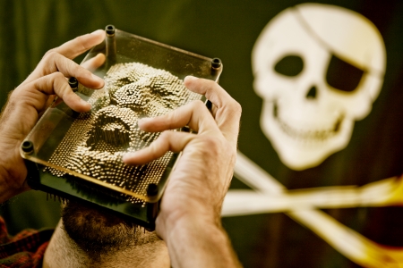 Man moulding a yelling face filled with anger with skull in backgroundの写真素材