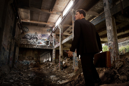 Confused Business man inside a completely Destroyed Building (concept)の写真素材