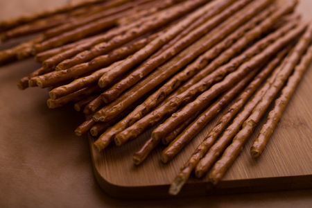 A bunch of salty bread sticks on the brown backgroundの写真素材
