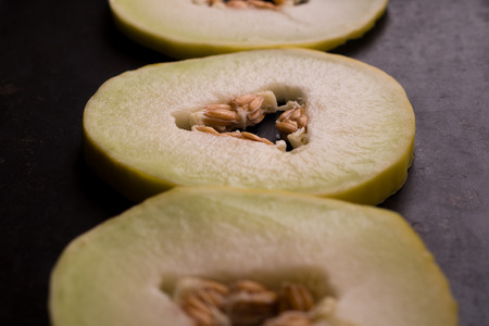 Yellow melon on the dark rustic metal backgroundの写真素材