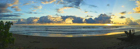 Gorgeous sunset on Playa Dominical in the sounthern part of Costa Ricaの写真素材