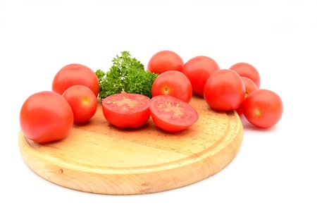 Tomatoes on wooden plateの写真素材