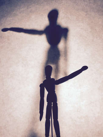 Concept of select. Wooden figurine and shadowの写真素材