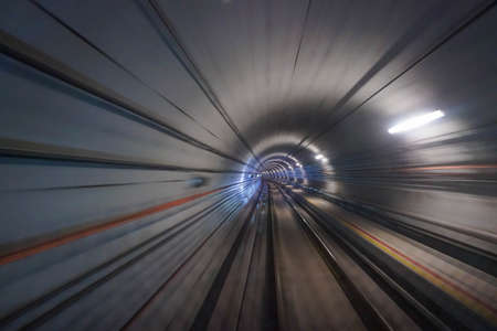 Riding train through subway tunnel in Singaporeの写真素材
