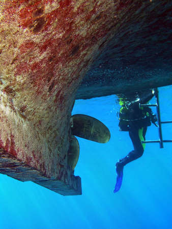 Diver after safety stop returns to boat   の写真素材