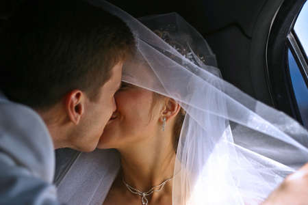 Kiss of a newly-married coupleの写真素材