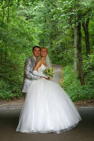 Newly-married couple in parkの写真素材