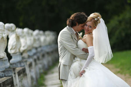 Newly-married couple. The groom kisses the brideの写真素材