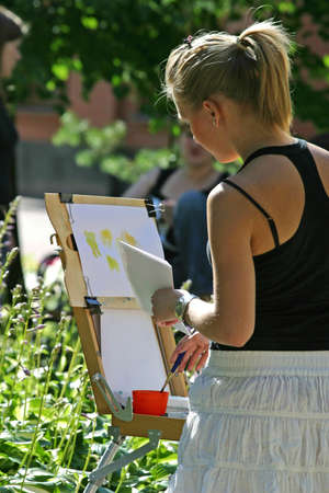 The girl draws paintsの写真素材