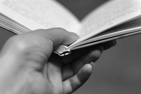 The female hand holds the open bookの写真素材