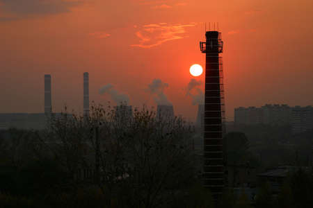 Factory pipes on a sunsetの写真素材