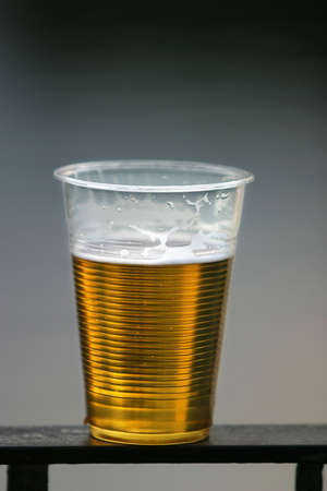 Plastic glass with beer on a dim backgroundの写真素材
