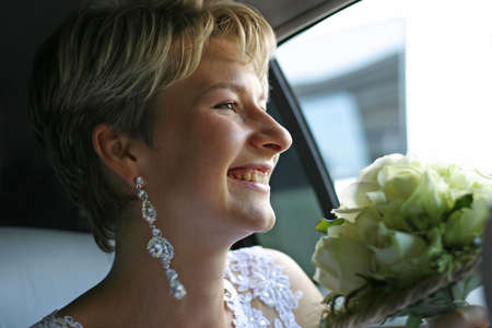 The laughing bride in the carの写真素材