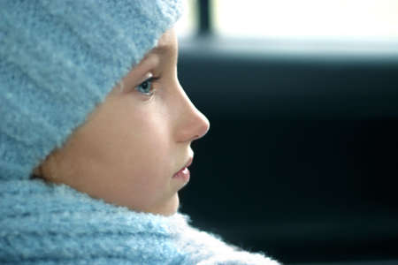 The beautiful little girl in blue looks to the rightの写真素材