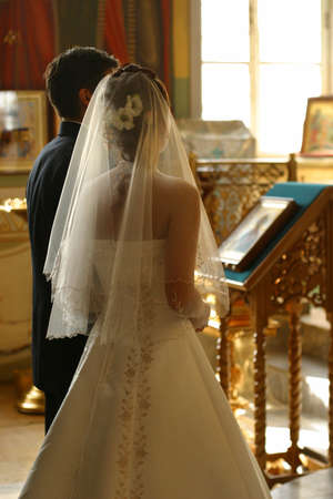 Newly-married couple in churchの写真素材