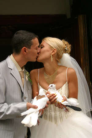 The groom and the bride with white pigeonsの写真素材