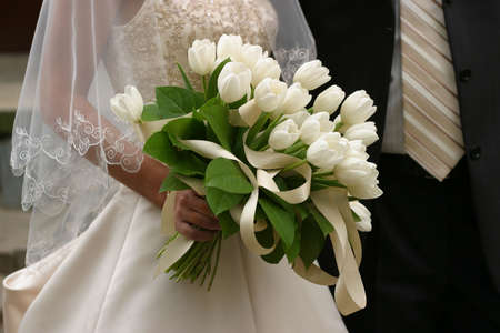Wedding bouquet in hands of the groom and the brideの写真素材