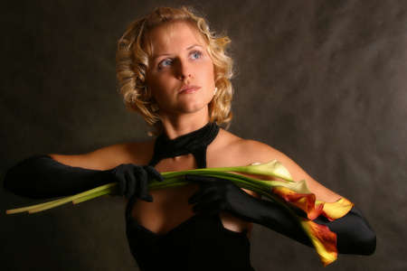 Portrait of the girl in a black dress with callasの写真素材