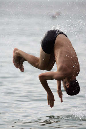 The boy jumps in waterの写真素材