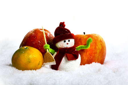 Toy of the snowman and apple in snowの写真素材