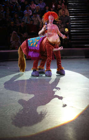 The clown in an image of the centaur on a circus ringの写真素材