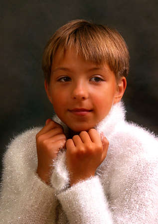 The girl sitting on a chair with handbells on a dark backgroundの写真素材