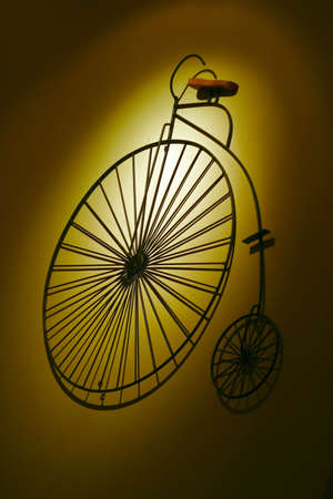 Ornament on a wall an ancient bicycleの写真素材