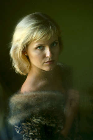 Woman with behind a wet window