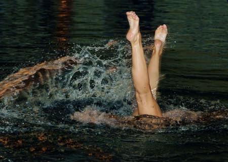 Legs of the sportsman in water with sparksの写真素材