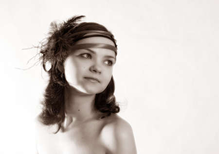 The beautiful girl in a hat in studio