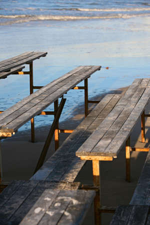 The image of wooden benches on a beachの写真素材