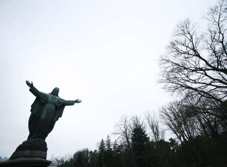 Jesus or God on a background of the sky and trees in park Palangaの写真素材