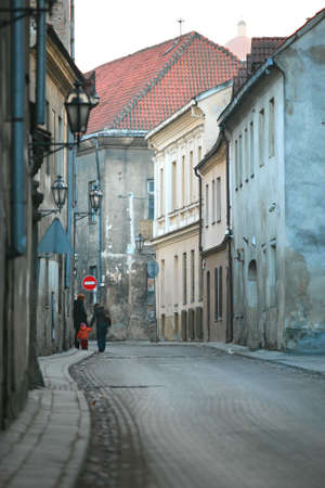 Two adult women and the small child go on old cityの写真素材