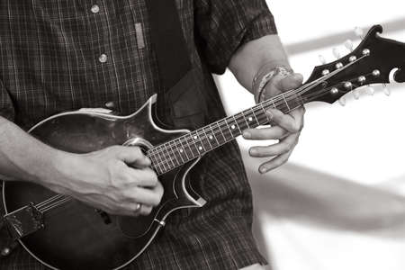 Part of a mandoline and hand man close-up. b/wの写真素材