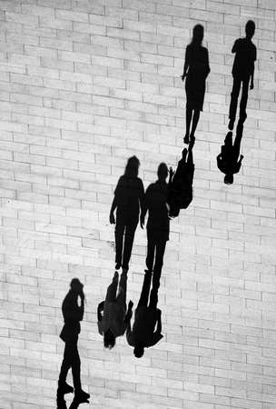 People and shadows in the streetの写真素材