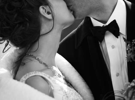 The groom and the bride kiss. b/wの写真素材