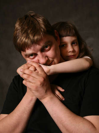 Double portrait. The daughter embraces the fatherの写真素材