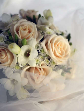 Wedding bouquet from beige roses in a veilの写真素材