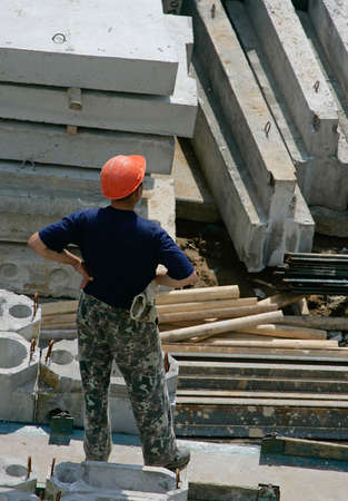 The builder stands among concrete plates